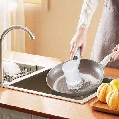 The cleaning brush is being used to wash a utensil to clean it better.